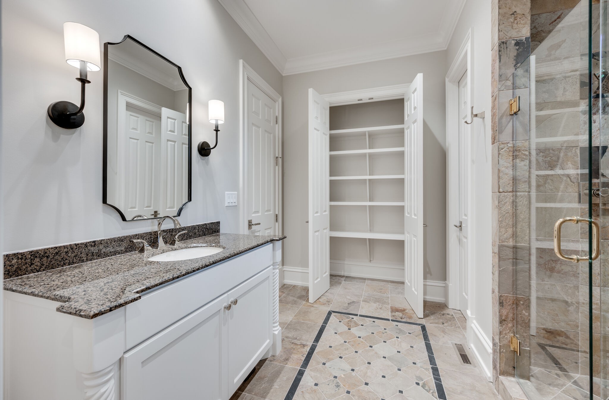1073 Vaughn Crest Boulevard Franklin, TN 37069 - Photo 32 of 70 a bathroom with a granite countertop sink a mirror and a shower