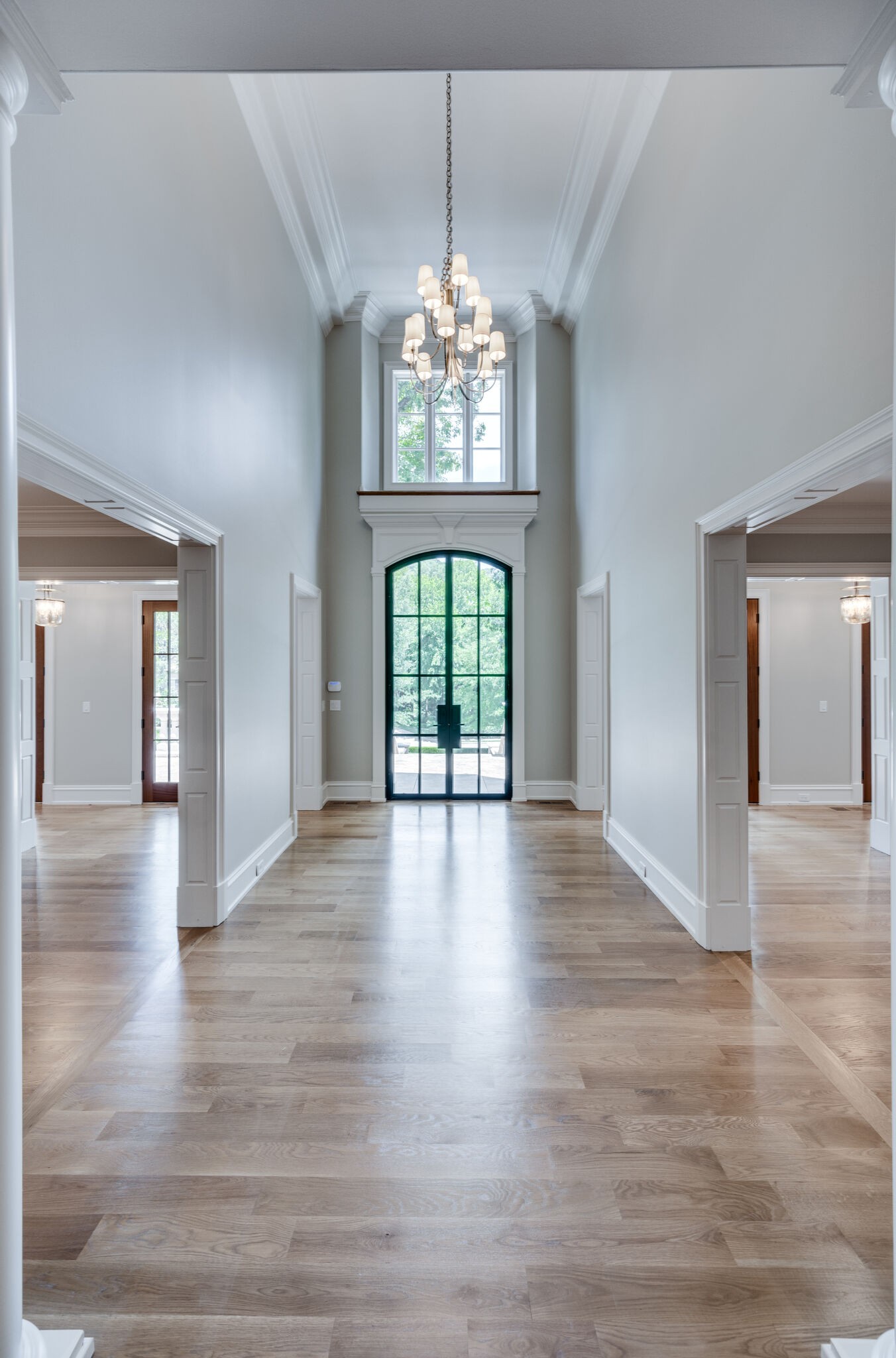 1073 Vaughn Crest Boulevard Franklin, TN 37069 - Photo 6 of 70 a view of an empty room with wooden floor and a window