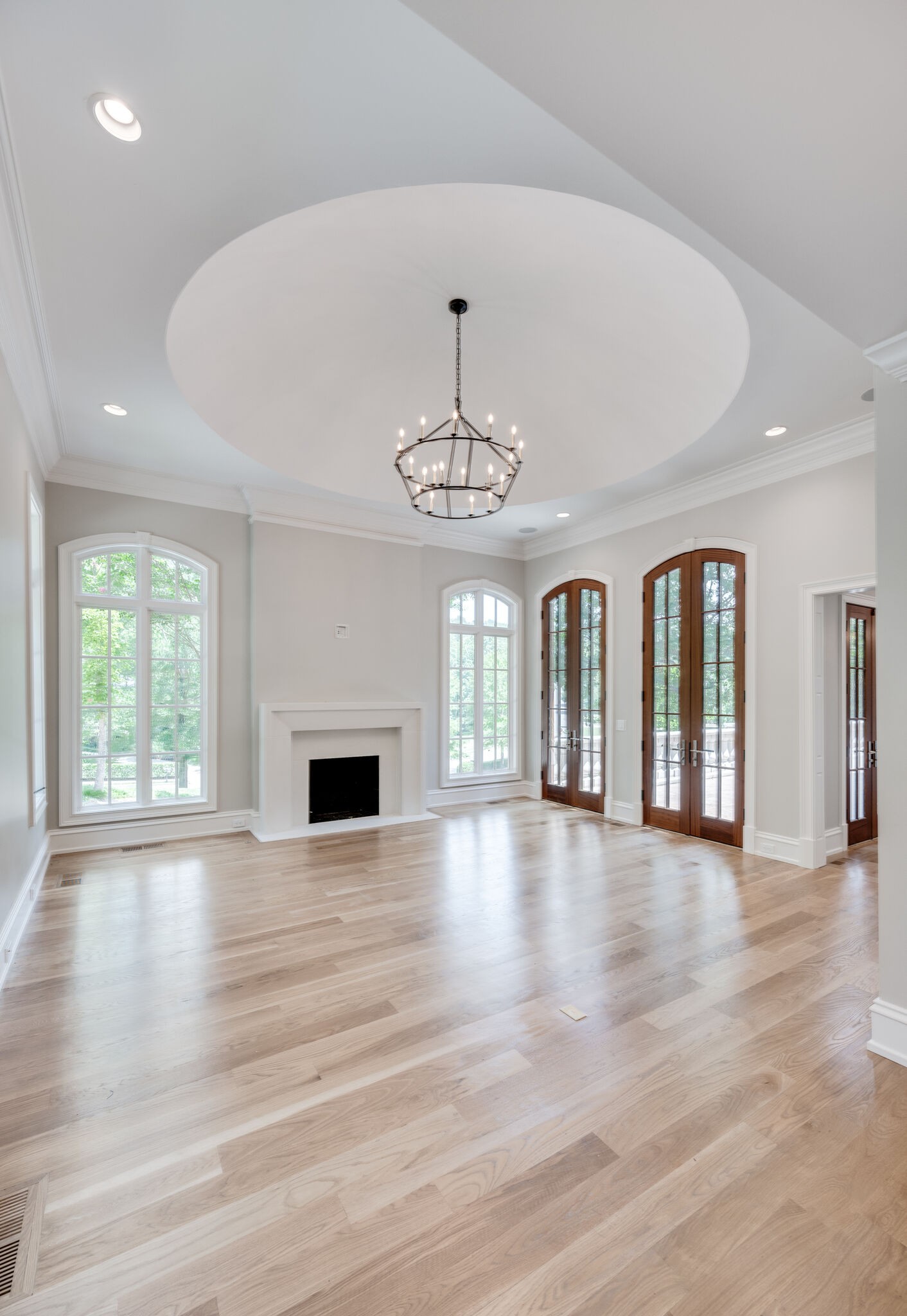1073 Vaughn Crest Boulevard Franklin, TN 37069 - Photo 8 of 70 an empty room with wooden floor chandelier and windows