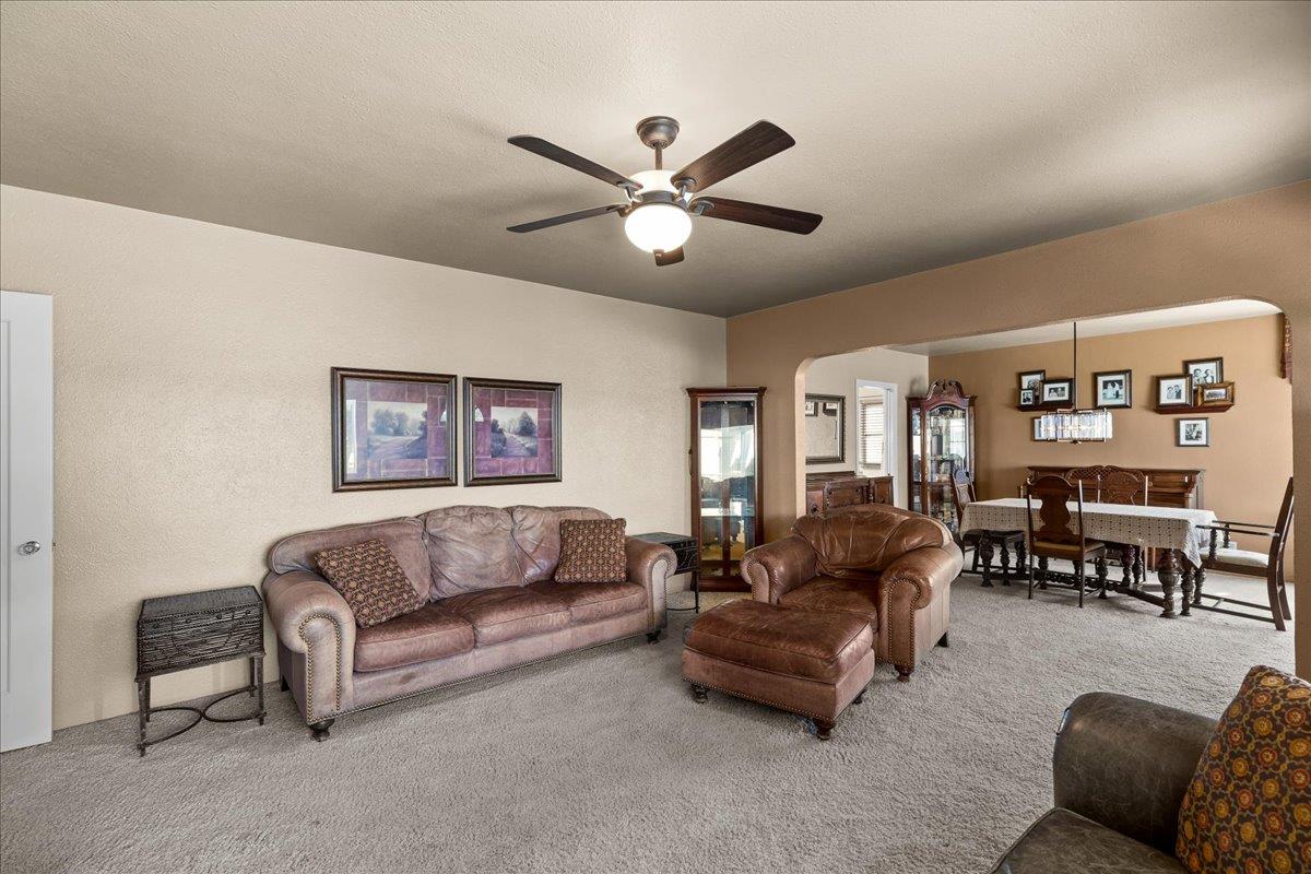 4701 Lone Tree Road Valley Home, CA 95361 - Photo 14 of 59 a living room with furniture and a chandelier