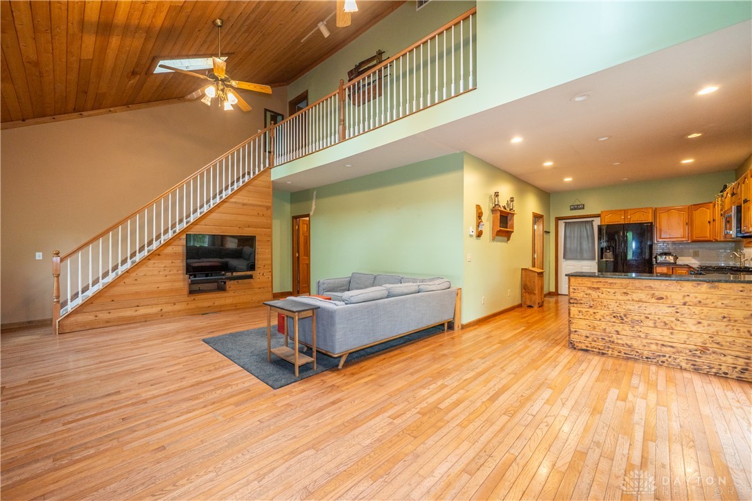 10584 New Biddinger Road Harrison, OH 45030 - Photo 4 of 61 This expansive open concept living space features a soaring ceiling and warm hardwood floors.