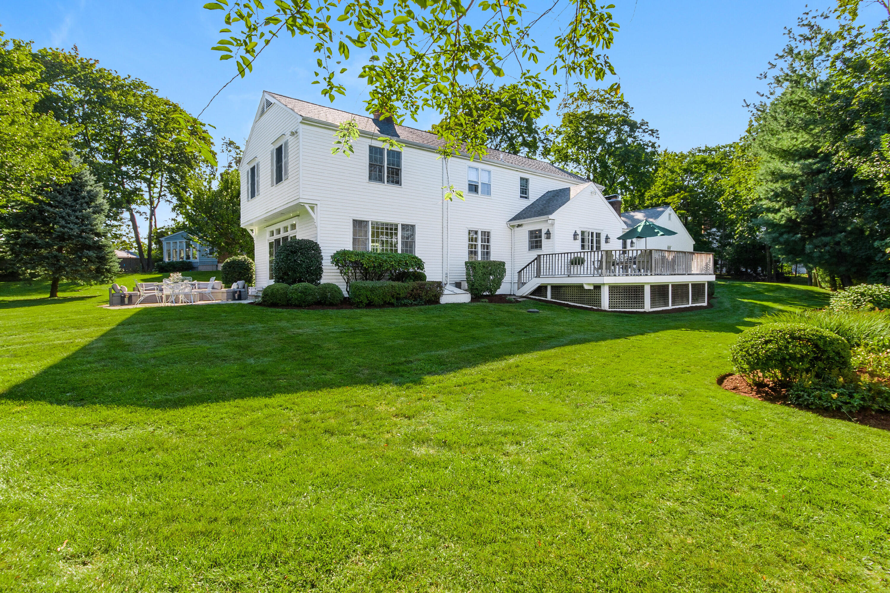 2 Hedge Row Darien, CT 06820 - Photo 30 of 38 a white house with a big yard plants and large trees
