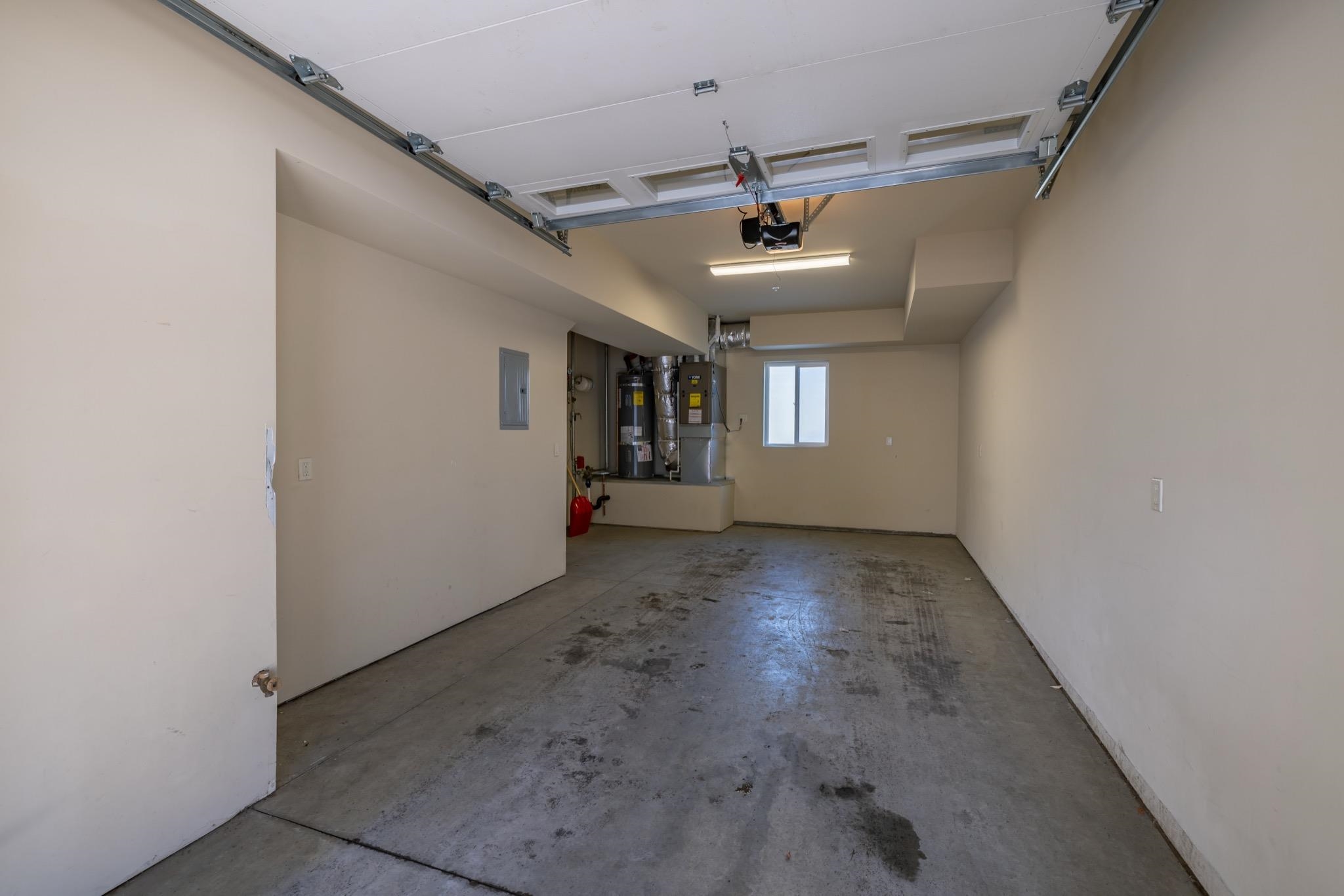 28 Oak Tree Way, Unit 8 Mammoth Lakes, CA 93546 - Photo 2 of 32 Garage featuring strapped water heater, heating unit, and electric panel