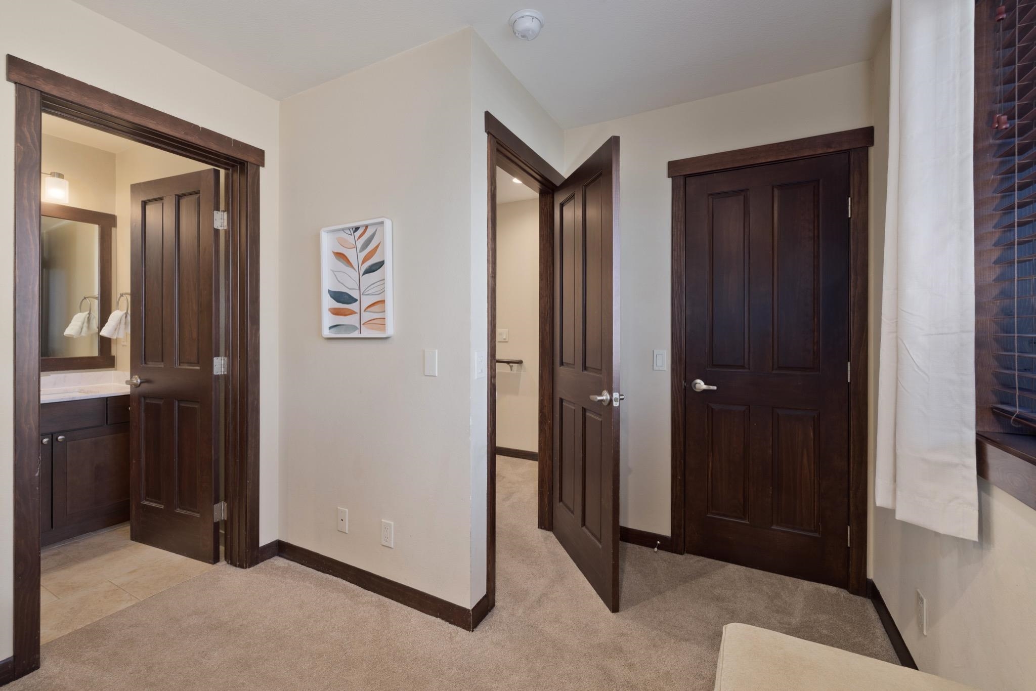 28 Oak Tree Way, Unit 8 Mammoth Lakes, CA 93546 - Photo 25 of 32 Hallway with light carpet and baseboards