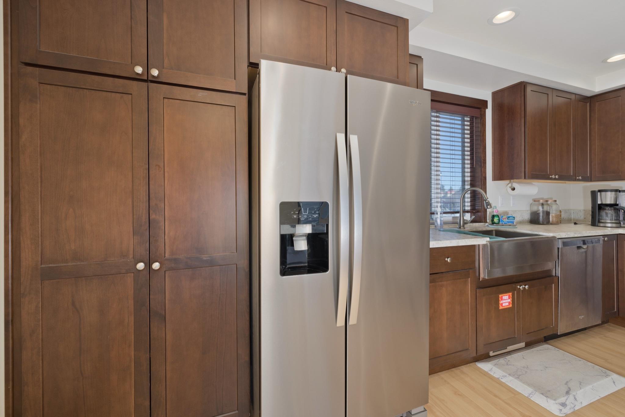 28 Oak Tree Way, Unit 8 Mammoth Lakes, CA 93546 - Photo 7 of 32 Kitchen with stainless steel appliances, light wood-type flooring, light stone counters, dark wood finish cabinetry, and recessed lighting