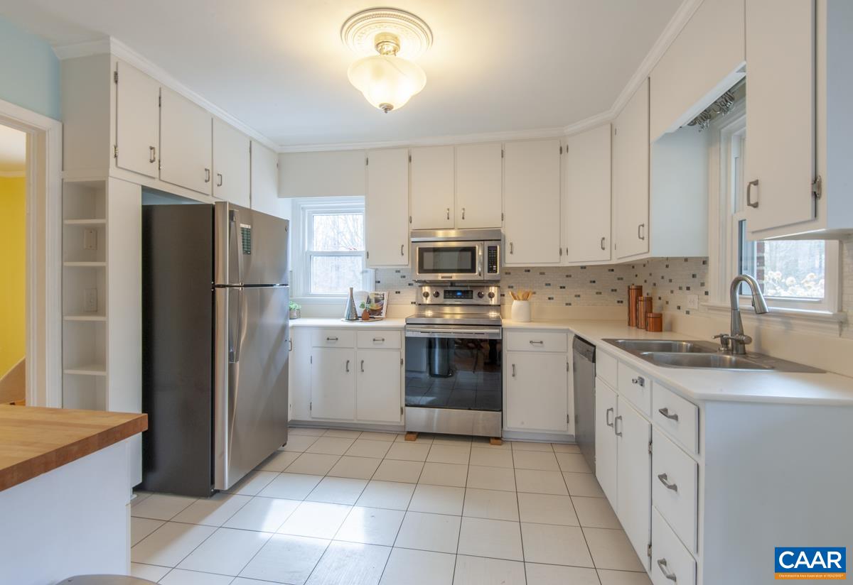 1606 Grove Road Charlottesville, VA 22901 - Photo 12 of 52 a kitchen with white cabinets sink and stainless steel appliances