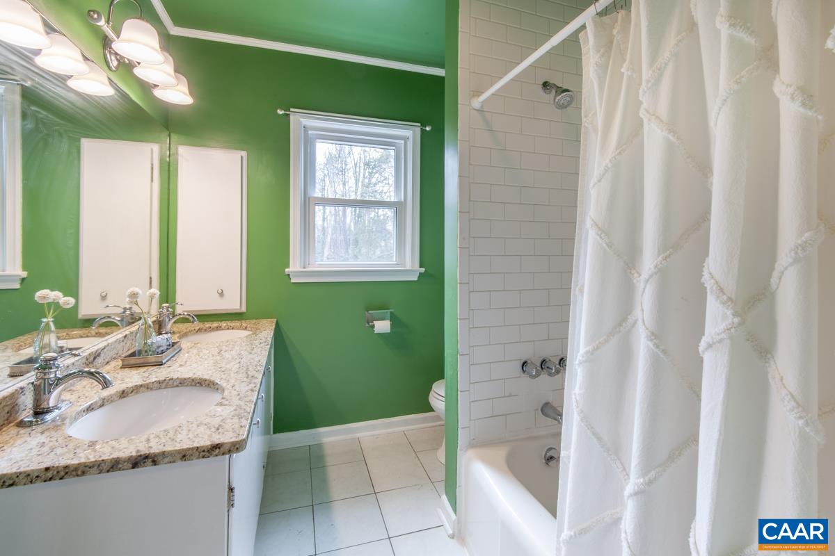 1606 Grove Road Charlottesville, VA 22901 - Photo 26 of 52 a bathroom with a granite countertop sink and a mirror