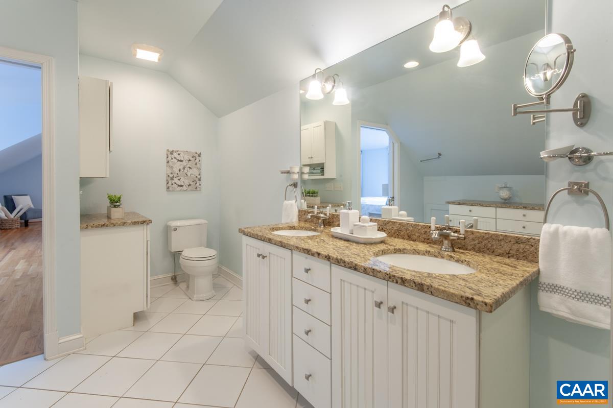 1606 Grove Road Charlottesville, VA 22901 - Photo 34 of 52 a bathroom with a granite countertop sink a toilet and a mirror