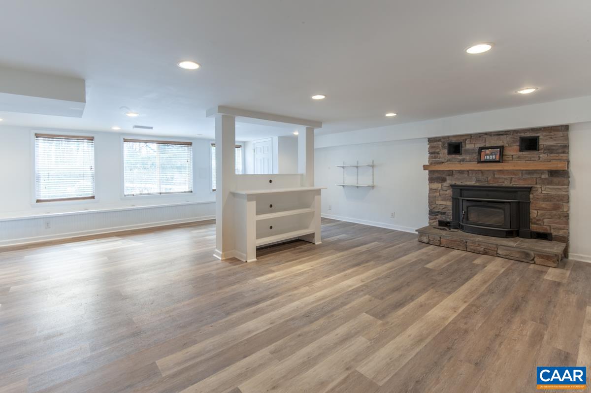 1606 Grove Road Charlottesville, VA 22901 - Photo 37 of 52 an empty room with furniture and a fireplace