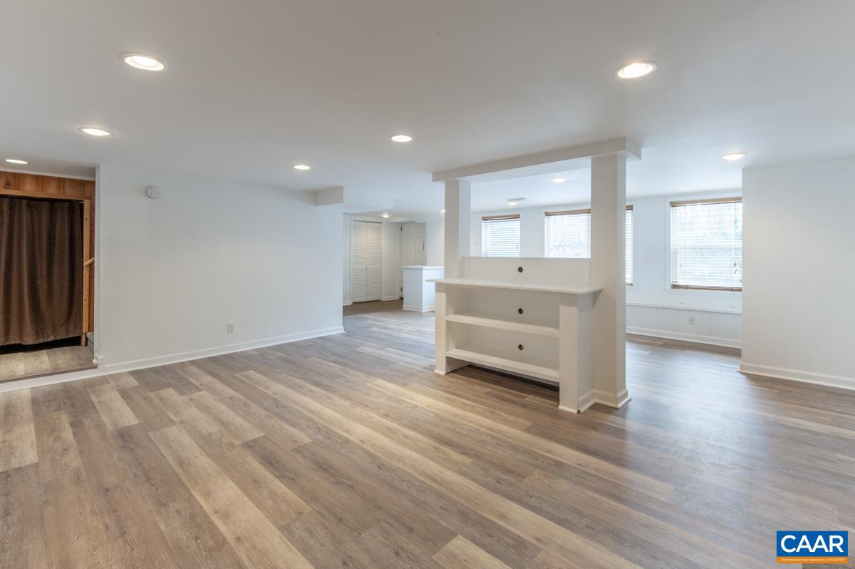 1606 Grove Road Charlottesville, VA 22901 - Photo 38 of 52 a living room with hard wood floors and a kitchen