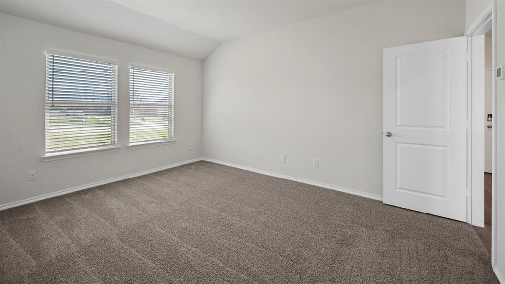 1913 Freeman Street Tyler, TX 75704 - Photo 10 of 21 Unfurnished room with dark colored carpet and lofted ceiling