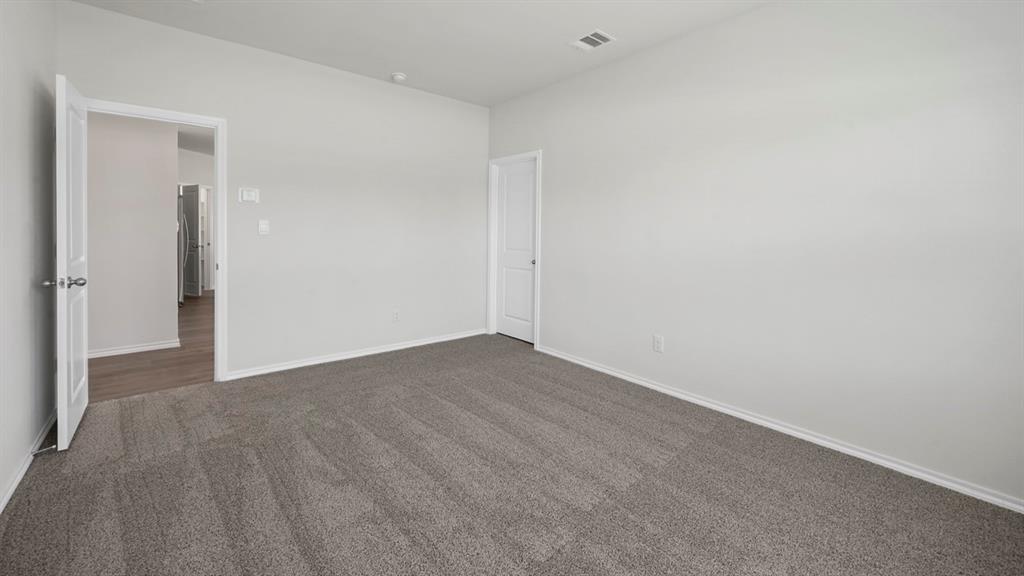 1913 Freeman Street Tyler, TX 75704 - Photo 12 of 21 Unfurnished bedroom featuring dark colored carpet and baseboards