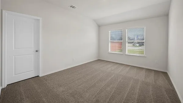 a view of an empty room and a window