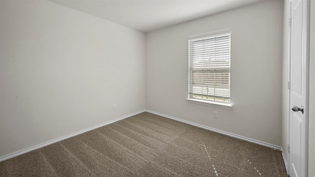 1913 Freeman Street Tyler, TX 75704 - Photo 15 of 21 Unfurnished room with dark colored carpet and baseboards