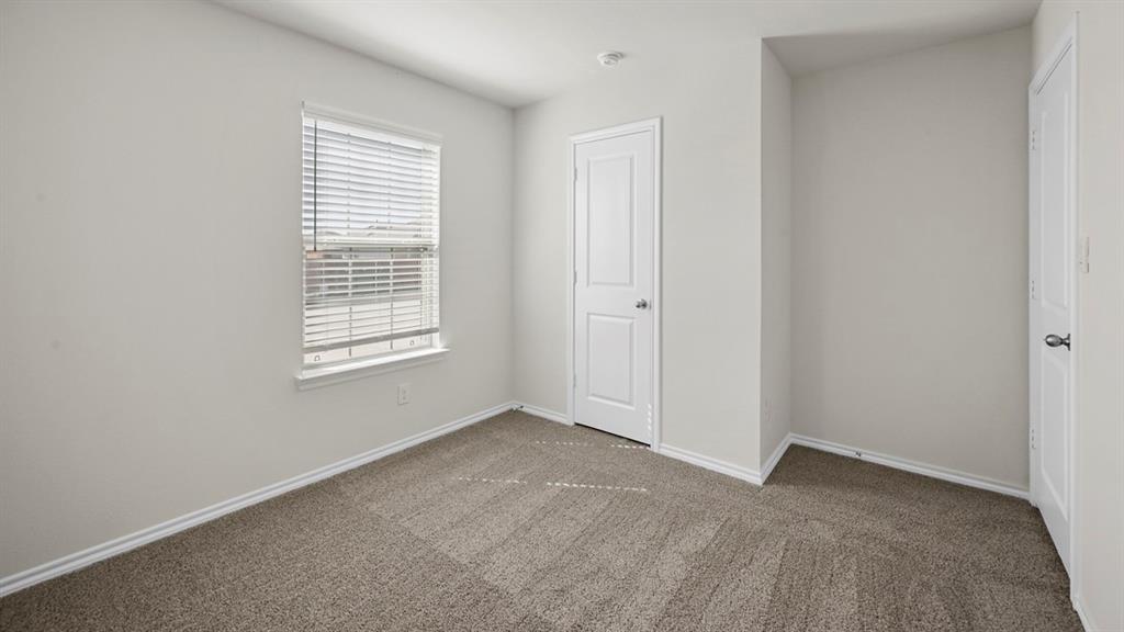 1913 Freeman Street Tyler, TX 75704 - Photo 16 of 21 Unfurnished bedroom with dark colored carpet and baseboards