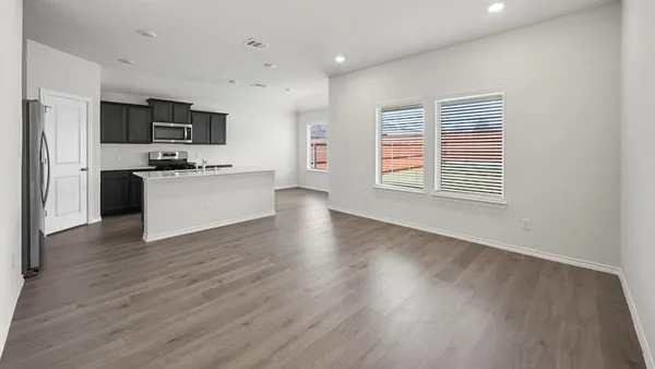 a view of an empty room and a window