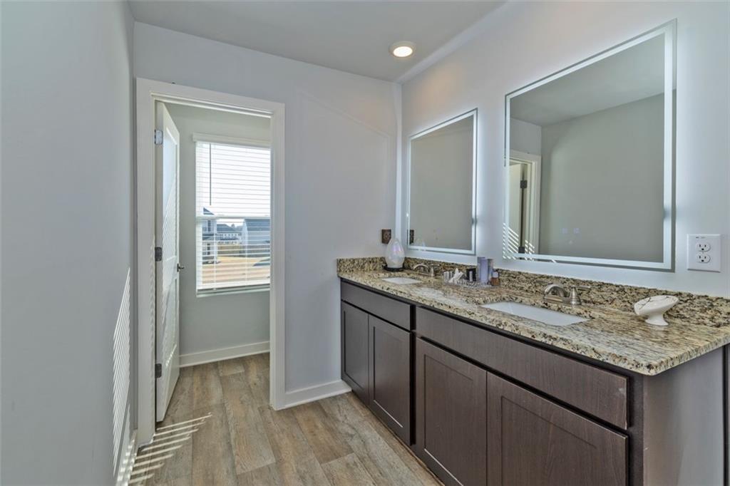244 Overlook Road Covington, GA 30014 - Photo 12 of 24 a bathroom with a granite countertop sink and a mirror