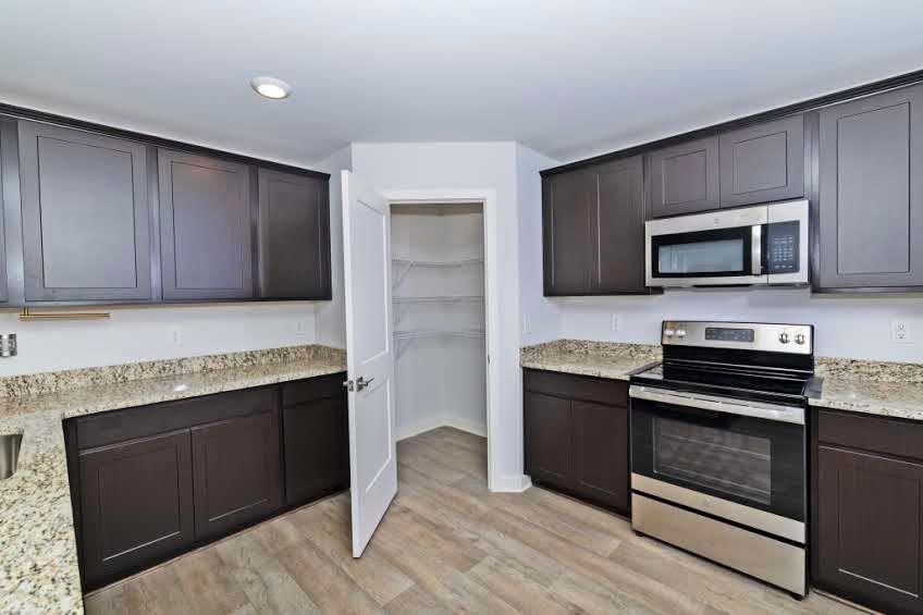 244 Overlook Road Covington, GA 30014 - Photo 6 of 24 a kitchen with a stove and a microwave