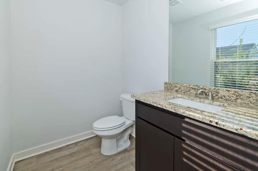244 Overlook Road Covington, GA 30014 - Photo 10 of 24 a bathroom with a granite countertop sink and a toilet