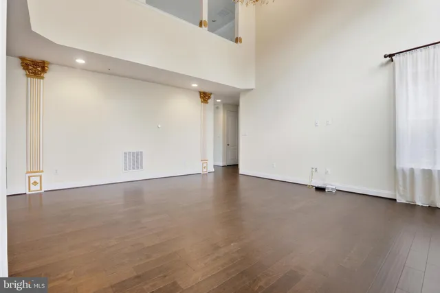 a living room with furniture fireplace and a large window