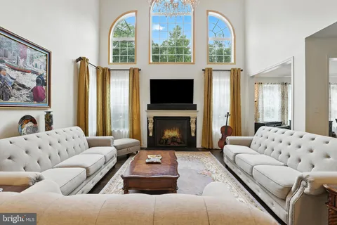 a view of a living room with furniture and a fireplace