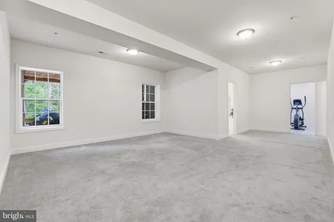 a view of a porch with furniture and a yard