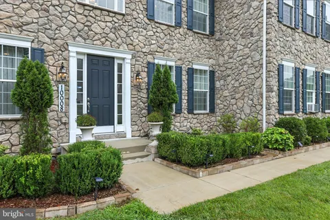 a living room with lots of furniture and a wooden floor