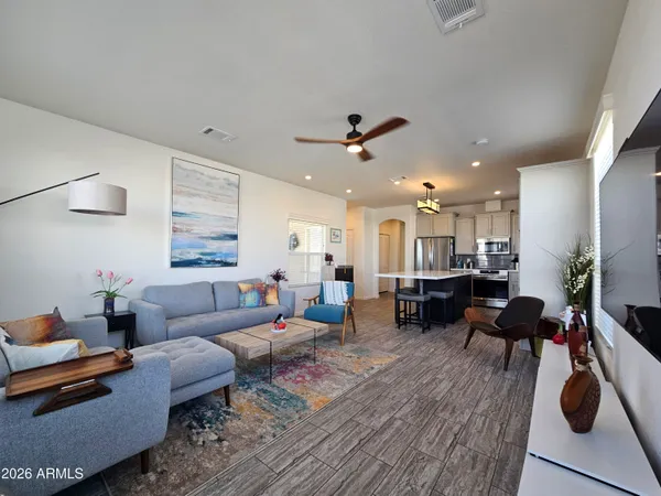 a living room with furniture and wooden floor
