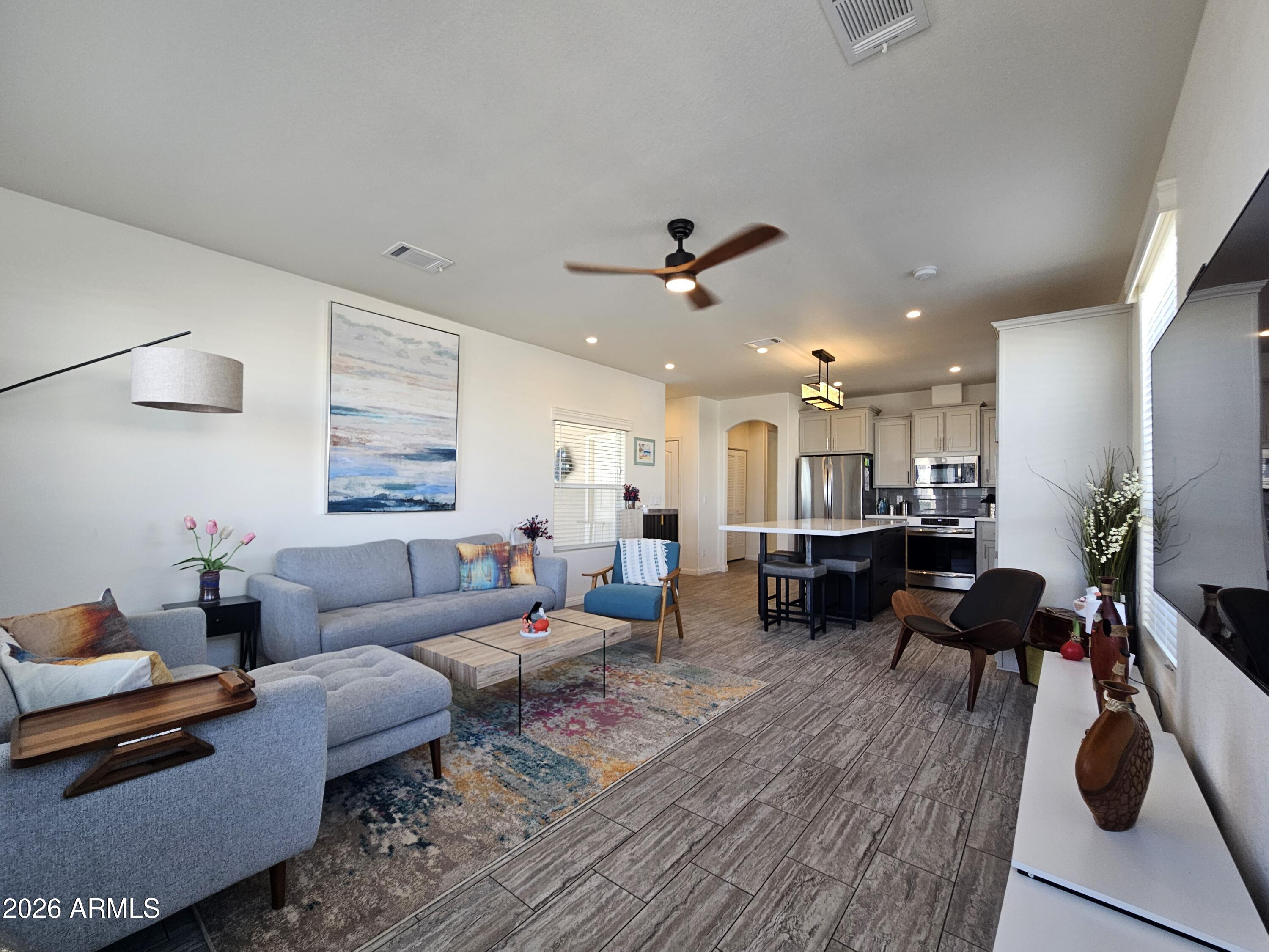 650 North Hawes Road, Unit 3331 Mesa, AZ 85207 - Photo 1 of 38 a living room with furniture and wooden floor