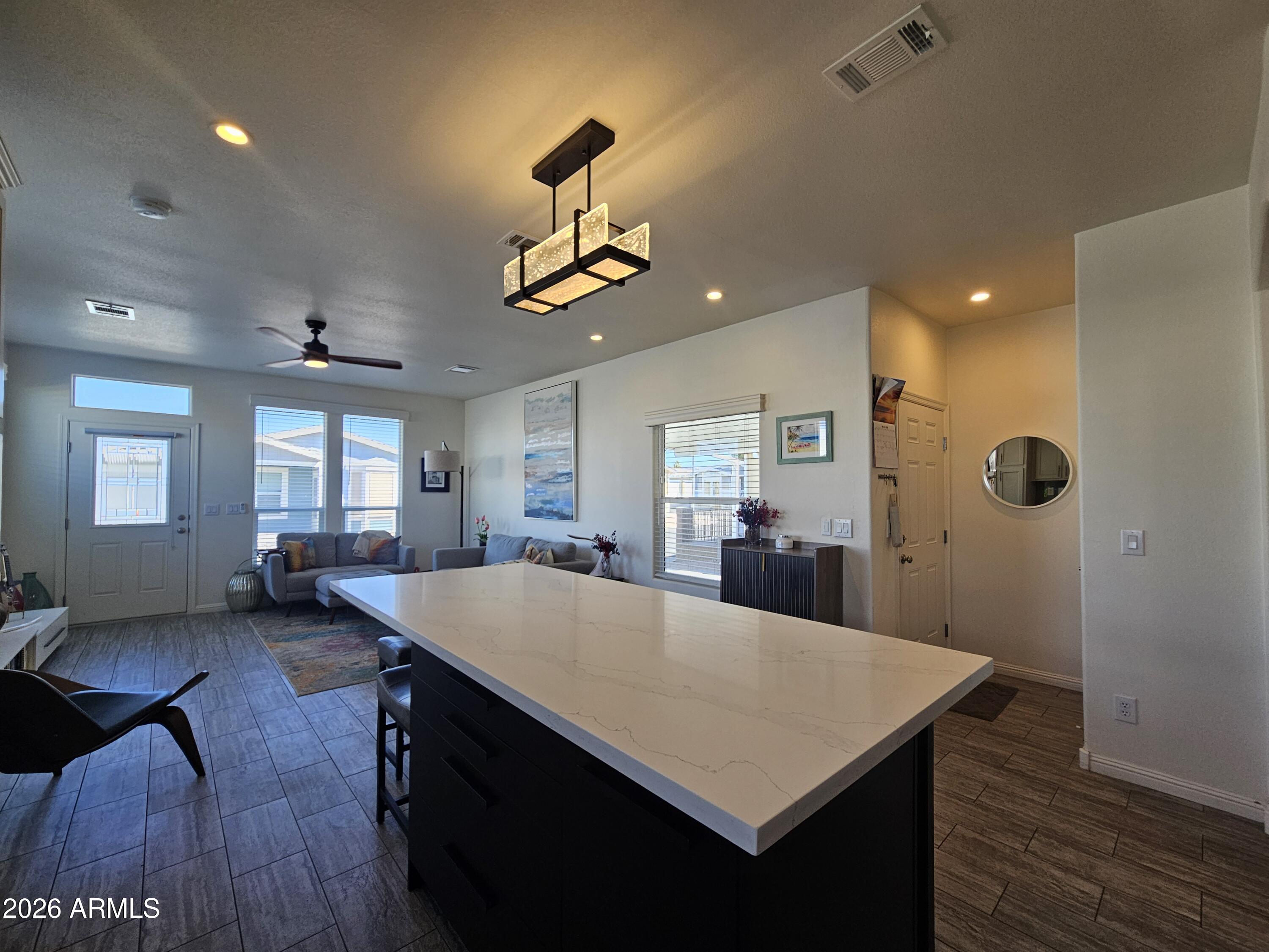 650 North Hawes Road, Unit 3331 Mesa, AZ 85207 - Photo 12 of 38 a large kitchen with stainless steel appliances a dining table chairs and wooden floor