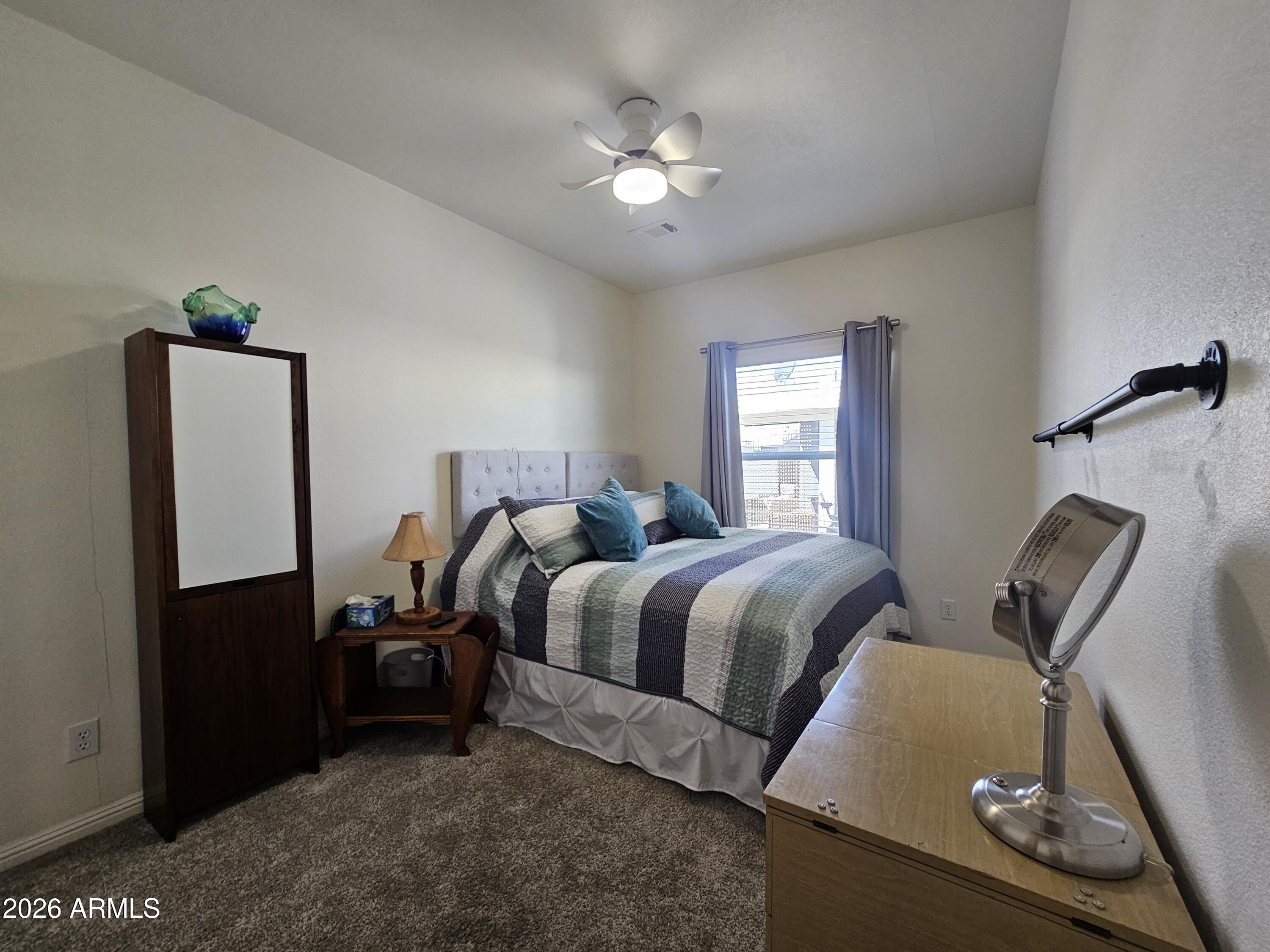 650 North Hawes Road, Unit 3331 Mesa, AZ 85207 - Photo 15 of 38 a bedroom with a bed and dresser