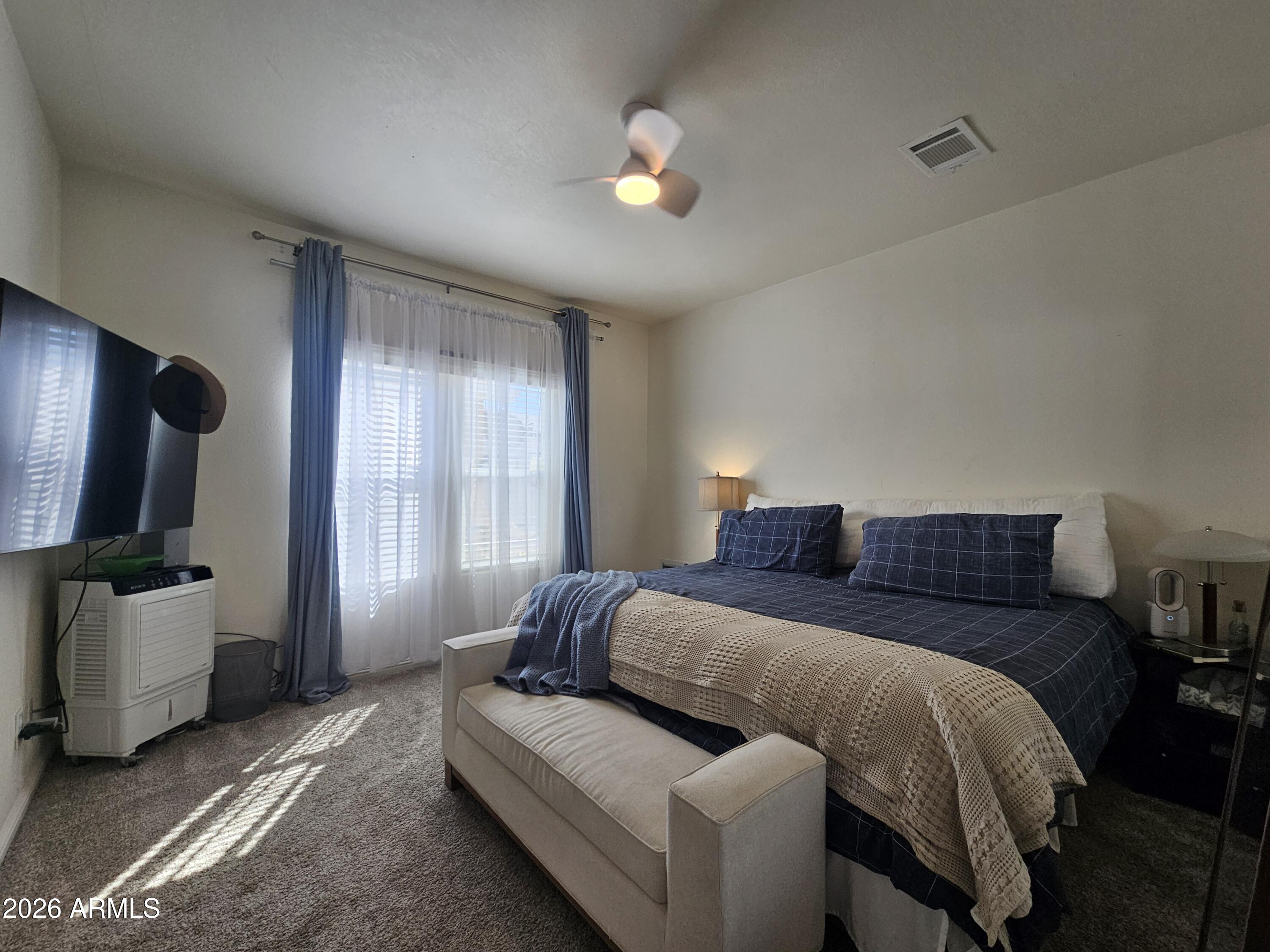 650 North Hawes Road, Unit 3331 Mesa, AZ 85207 - Photo 17 of 38 a bedroom with a bed and flat screen tv