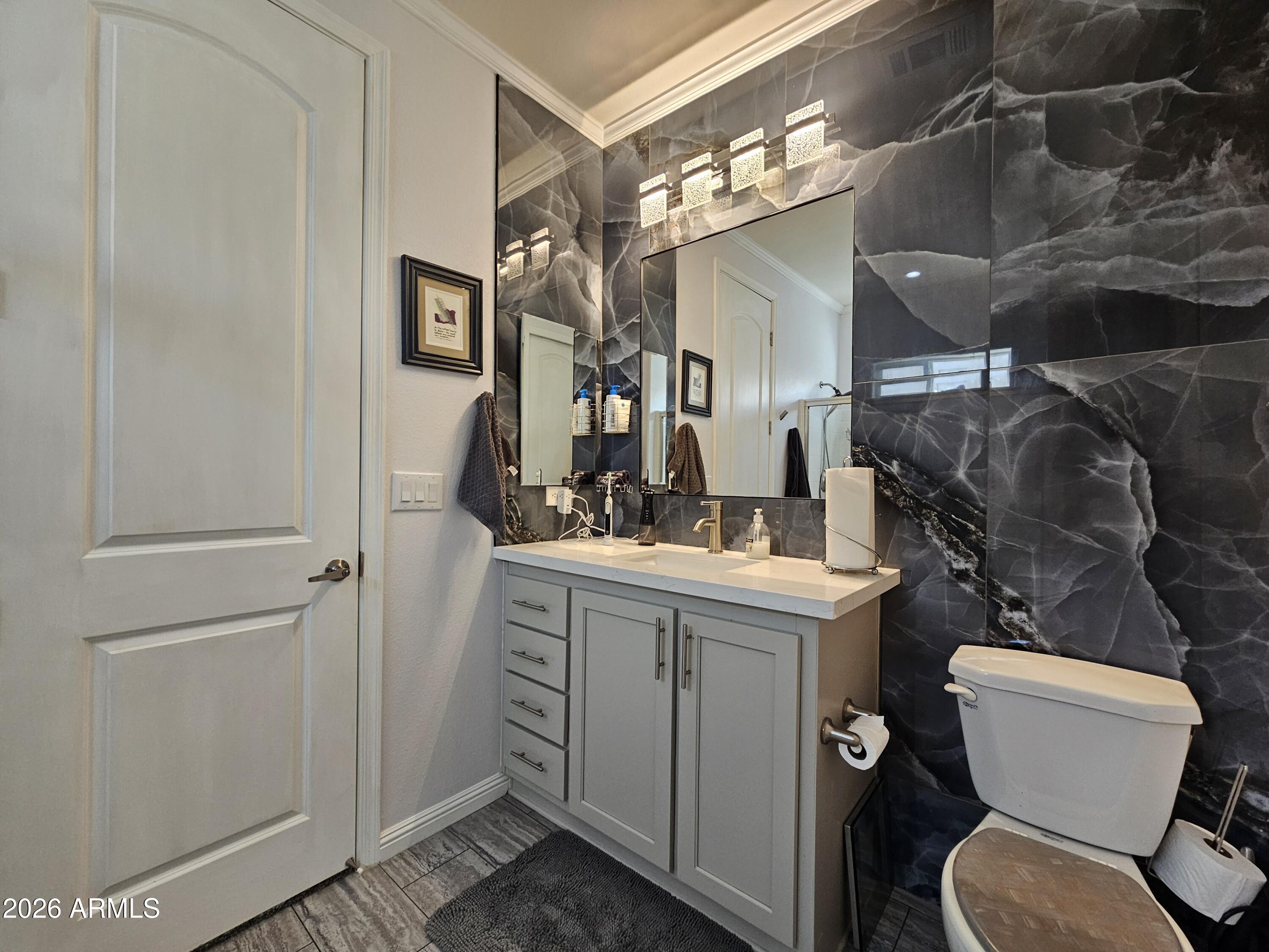 650 North Hawes Road, Unit 3331 Mesa, AZ 85207 - Photo 19 of 38 a bathroom with a toilet sink and mirror