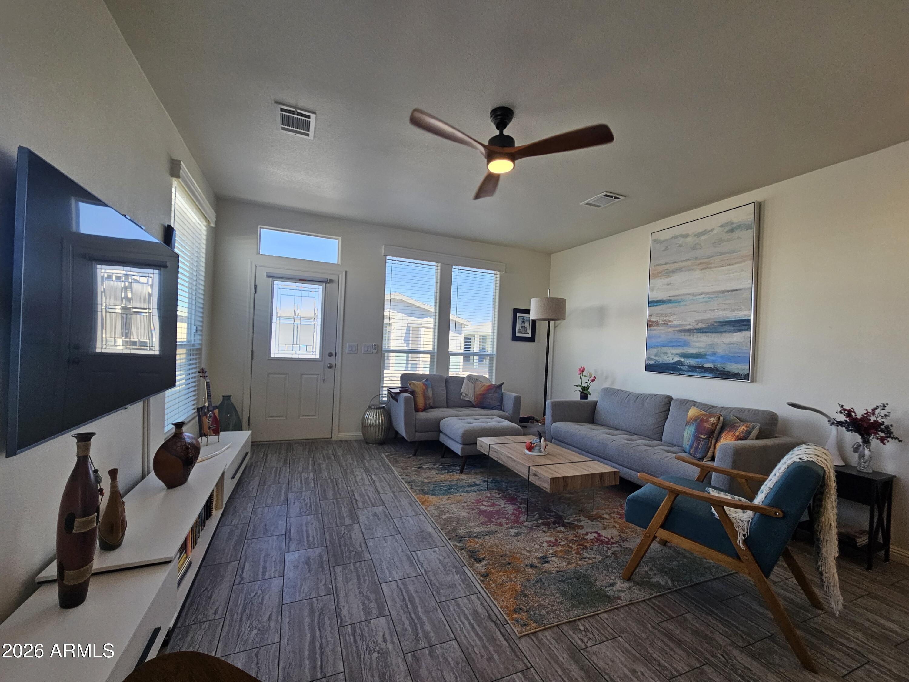 650 North Hawes Road, Unit 3331 Mesa, AZ 85207 - Photo 2 of 38 a living room with furniture and a wooden floor