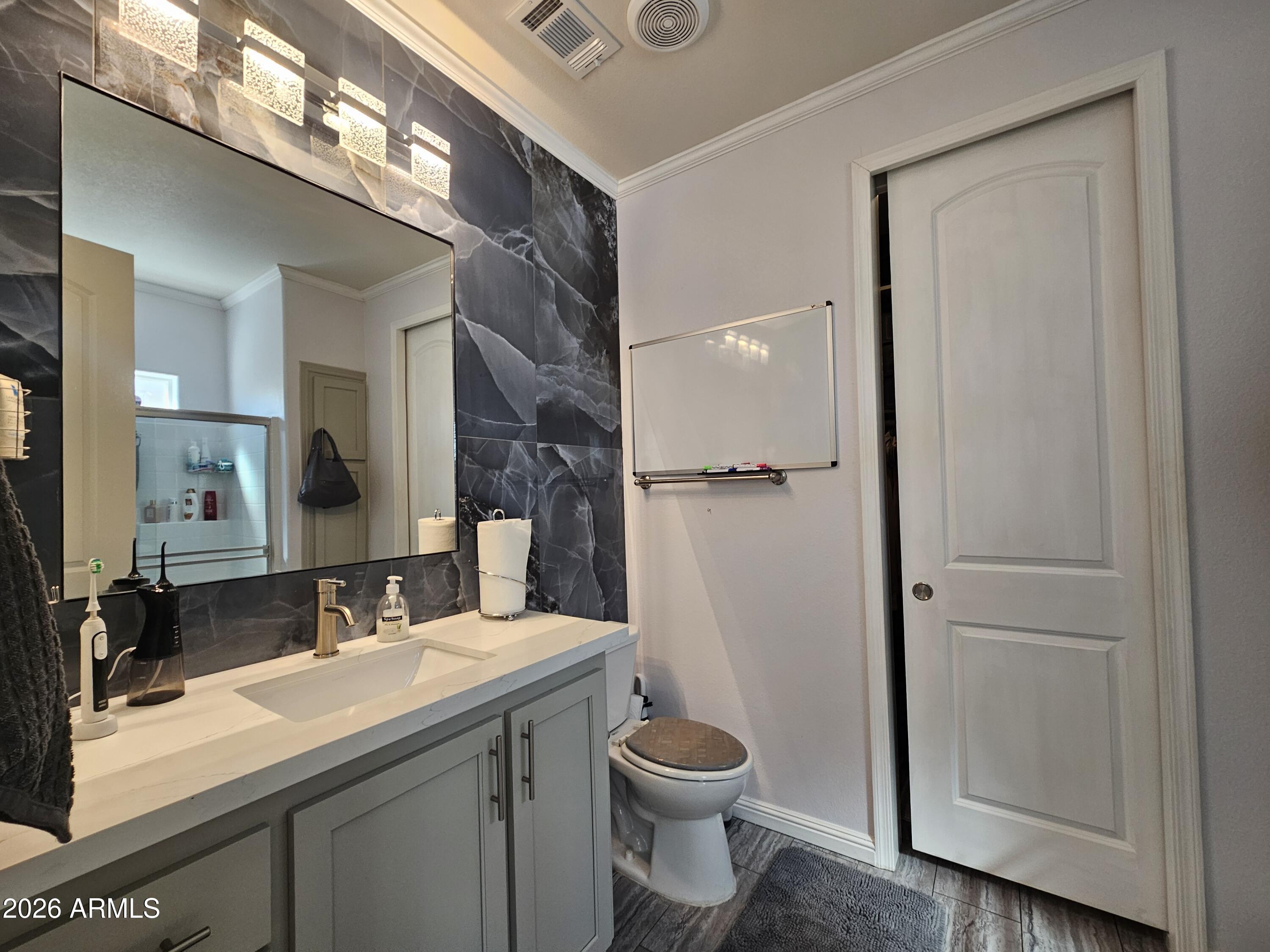 650 North Hawes Road, Unit 3331 Mesa, AZ 85207 - Photo 21 of 38 a bathroom with a granite countertop sink toilet and shower