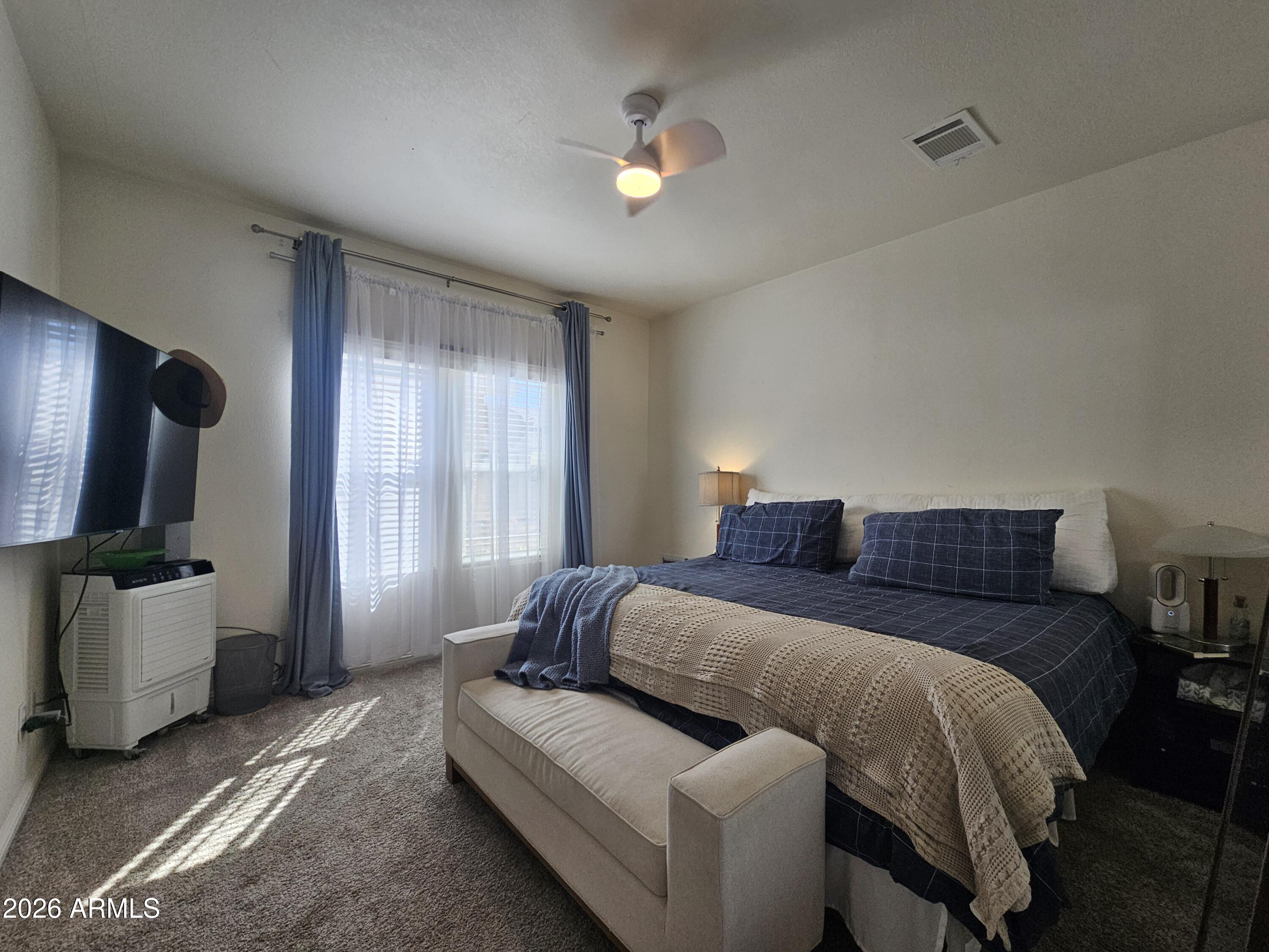 650 North Hawes Road, Unit 3331 Mesa, AZ 85207 - Photo 5 of 38 a bedroom with a bed and flat screen tv