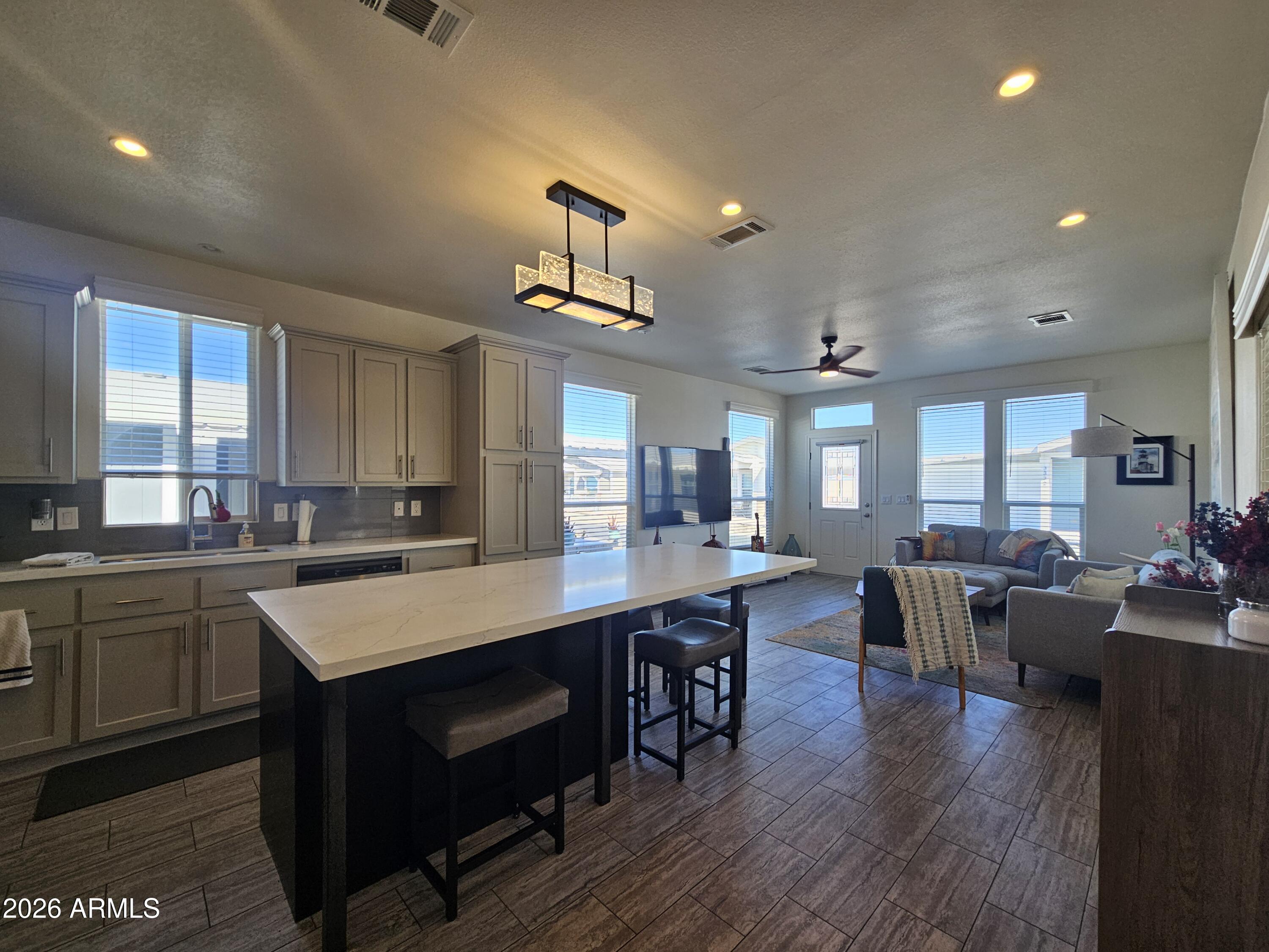650 North Hawes Road, Unit 3331 Mesa, AZ 85207 - Photo 9 of 38 a large kitchen with lots of counter space a sink appliances and dining table