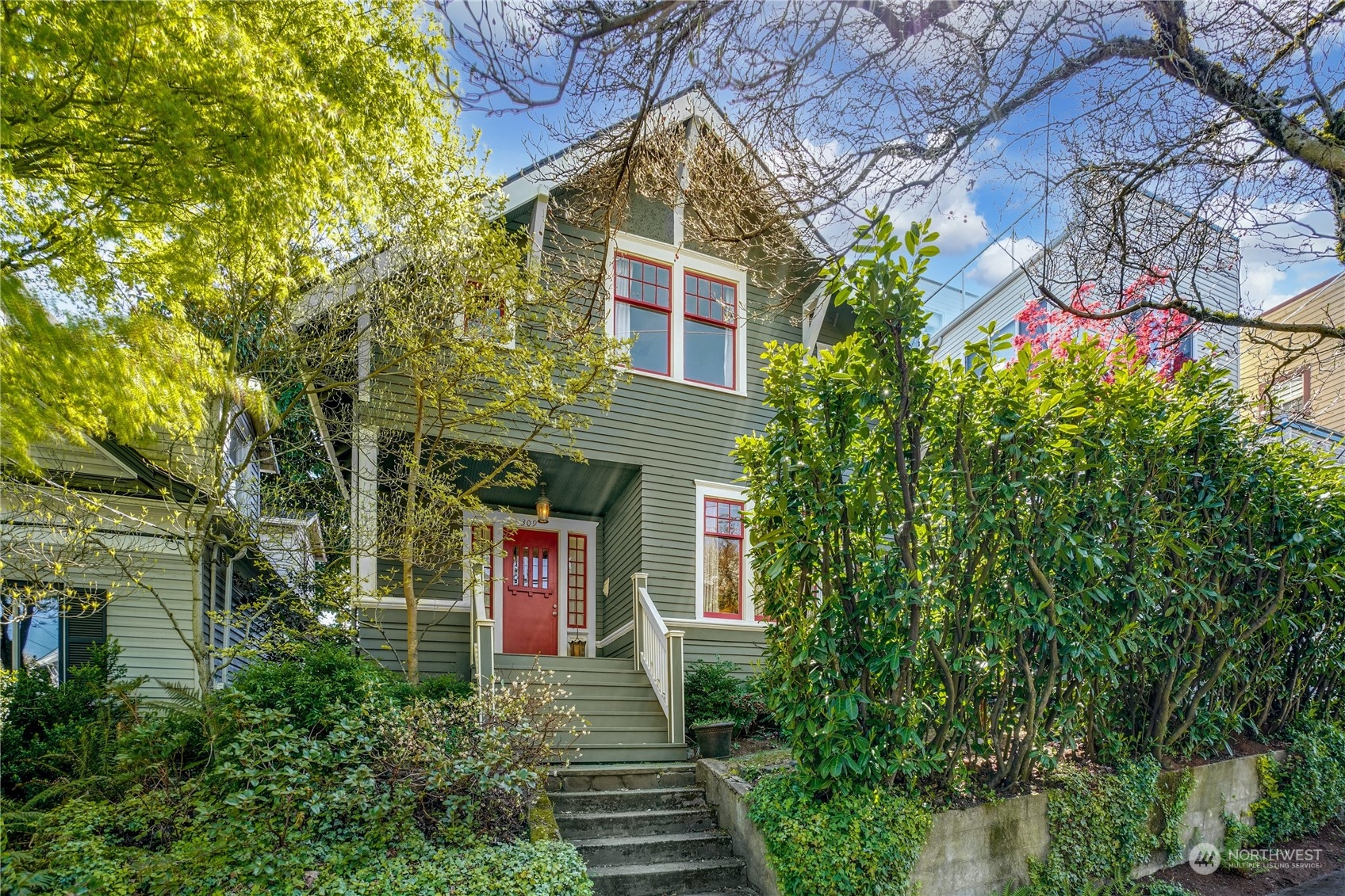 309 North 73rd Street Seattle, WA 98103 - Photo 1 of 30 a front view of a house with a yard and trees