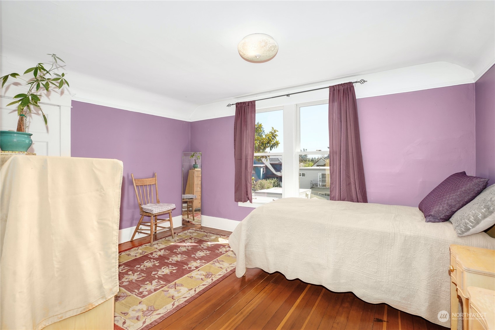 309 North 73rd Street Seattle, WA 98103 - Photo 12 of 30 a bedroom with a bed and wooden floor