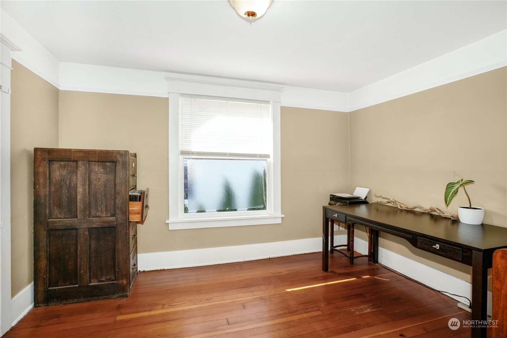 309 North 73rd Street Seattle, WA 98103 - Photo 13 of 30 a view of a workspace with furniture and wooden floor