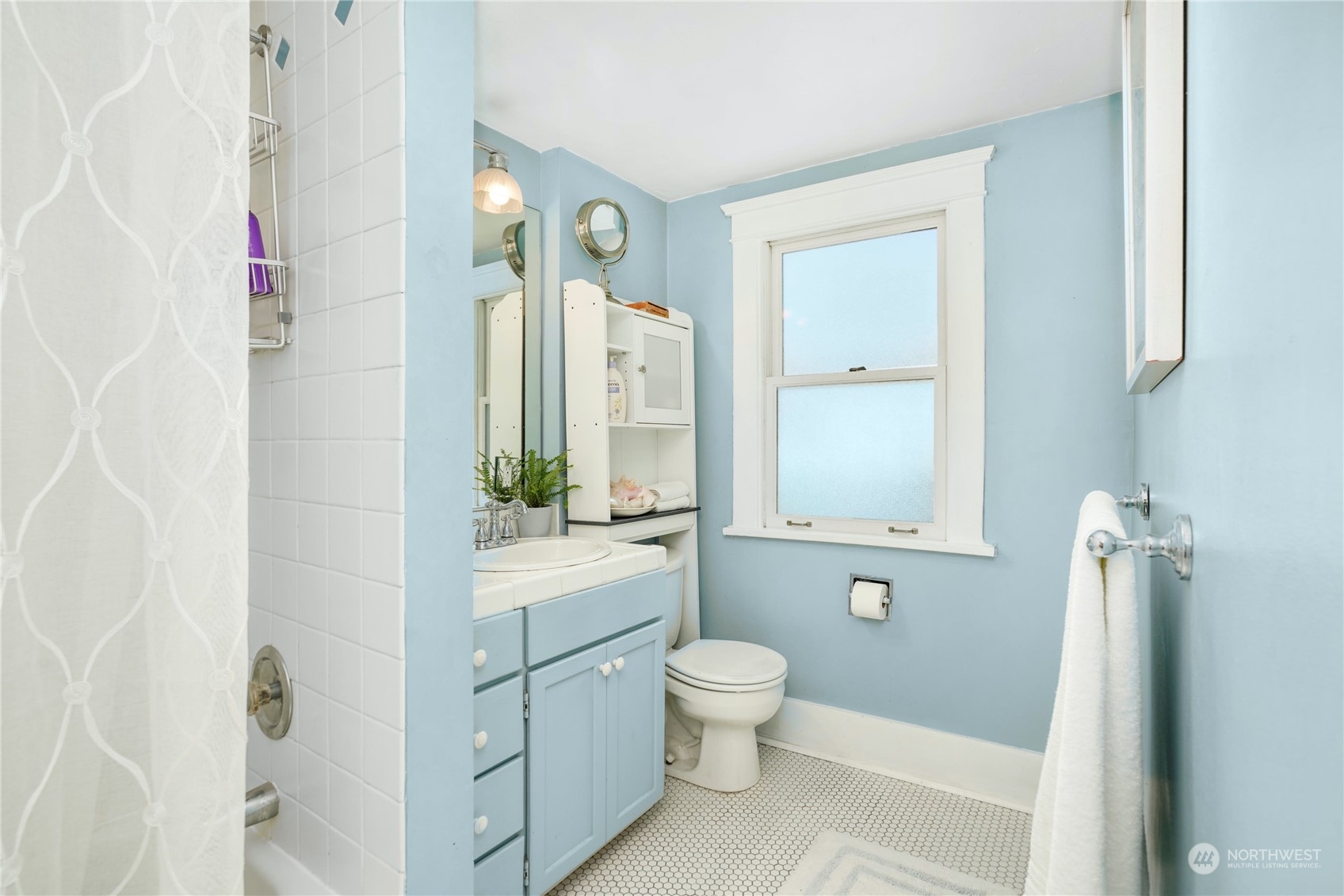 309 North 73rd Street Seattle, WA 98103 - Photo 14 of 30 a bathroom with a sink a toilet and shower