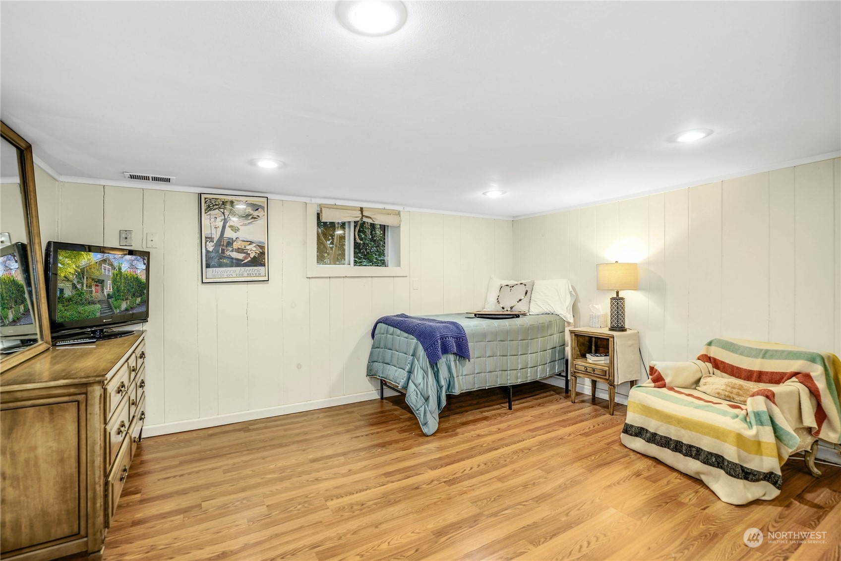 309 North 73rd Street Seattle, WA 98103 - Photo 16 of 30 a bedroom with furniture and a flat screen tv