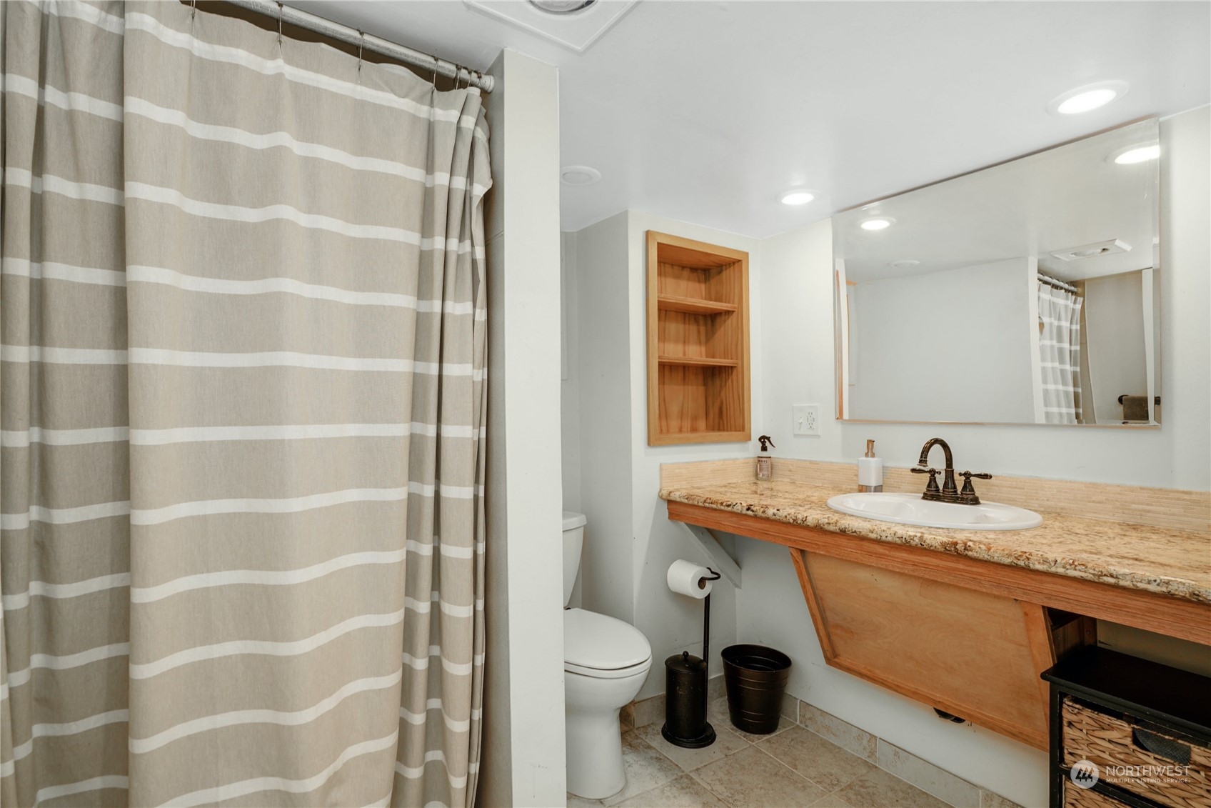 309 North 73rd Street Seattle, WA 98103 - Photo 19 of 30 a bathroom with a granite countertop sink a toilet and shower