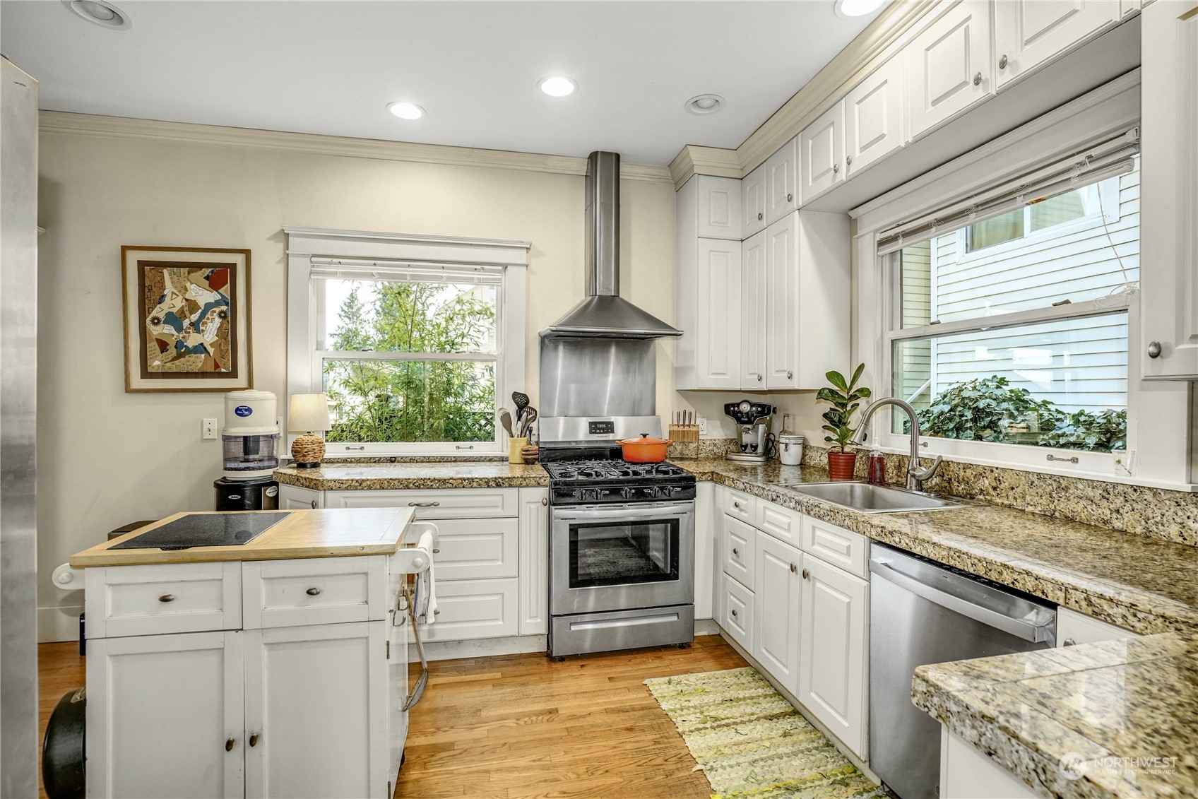 309 North 73rd Street Seattle, WA 98103 - Photo 8 of 30 a kitchen with stainless steel appliances granite countertop a stove and a sink