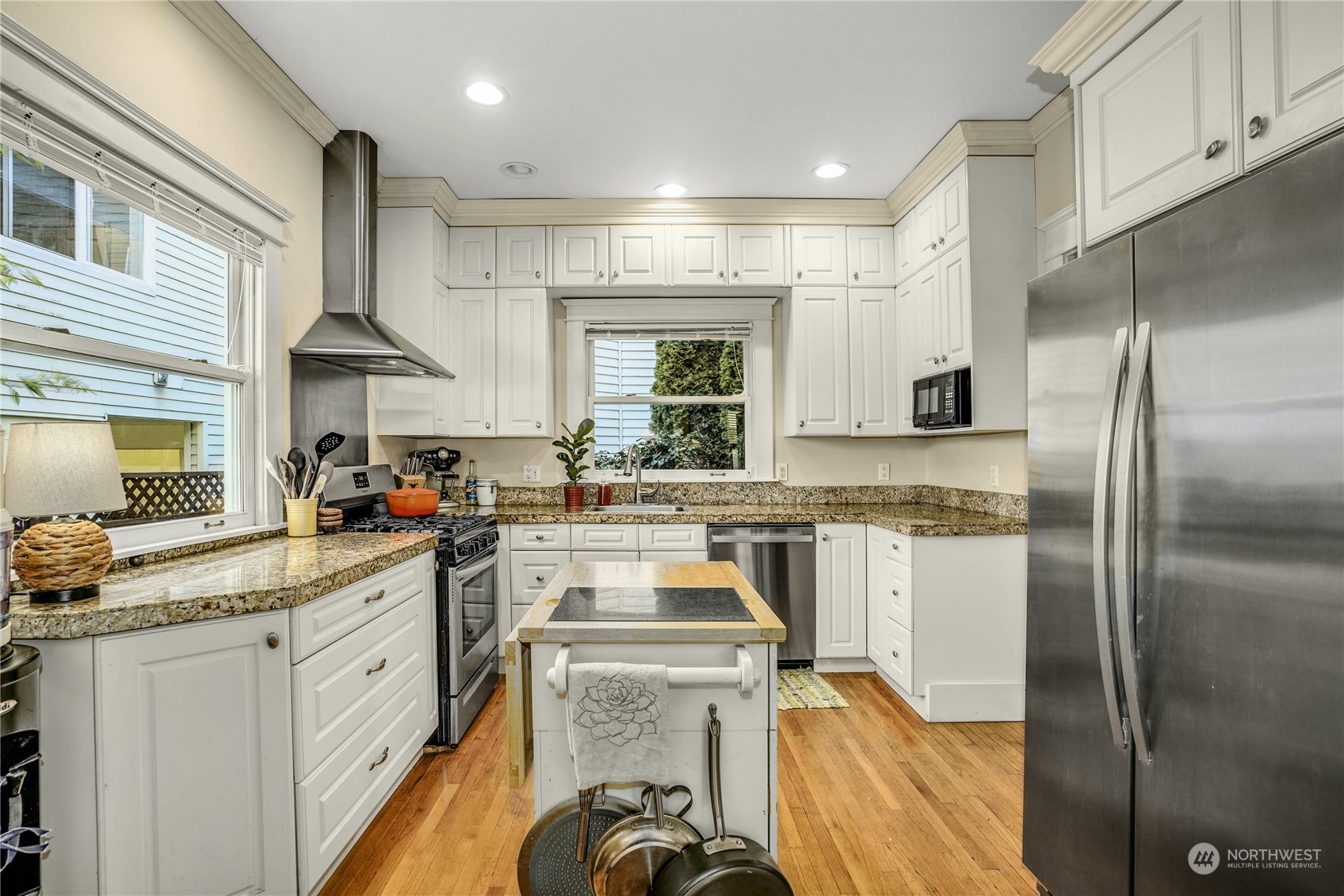 309 North 73rd Street Seattle, WA 98103 - Photo 9 of 30 a kitchen with a sink stove and refrigerator