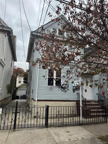 a view of a brick house with wooden fence