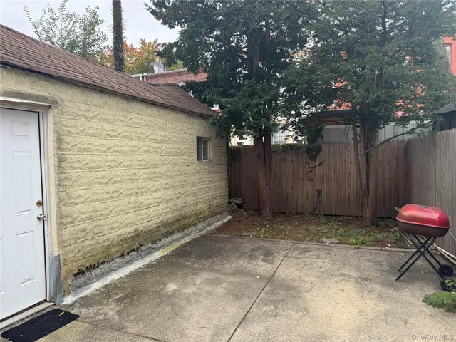a view of a backyard with a tree
