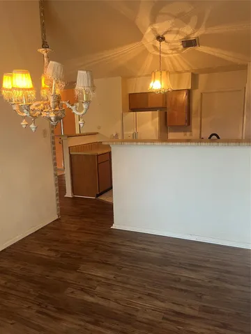 a view of a room with wooden floor