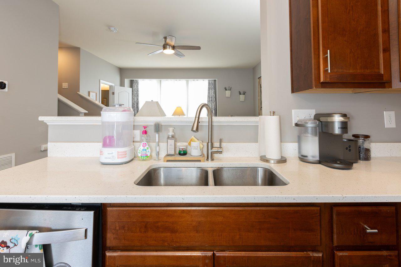 47 Landis Court Falling Waters, WV 25419 - Photo 11 of 35 a kitchen with kitchen island a sink and wooden cabinets