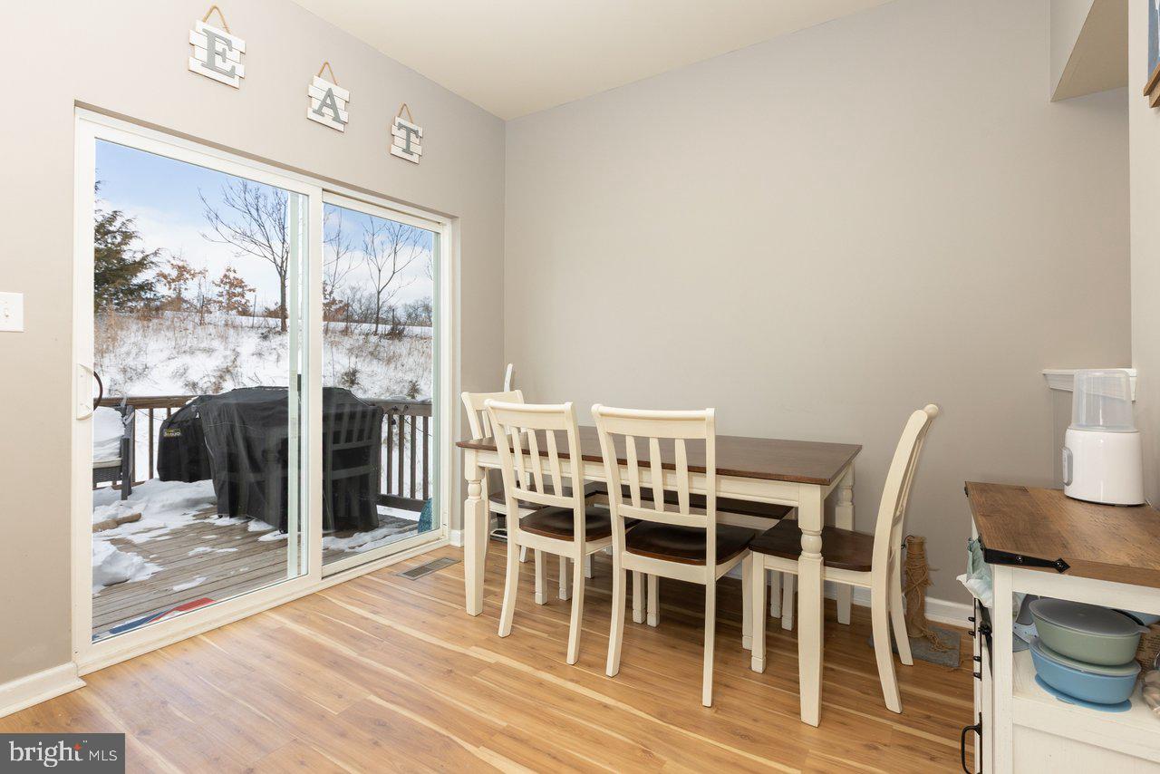 47 Landis Court Falling Waters, WV 25419 - Photo 22 of 35 a view of a dining room with furniture and wooden floor